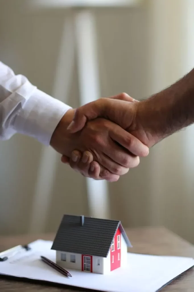 La Maison Mortgage Corporation handshake after closing home loan